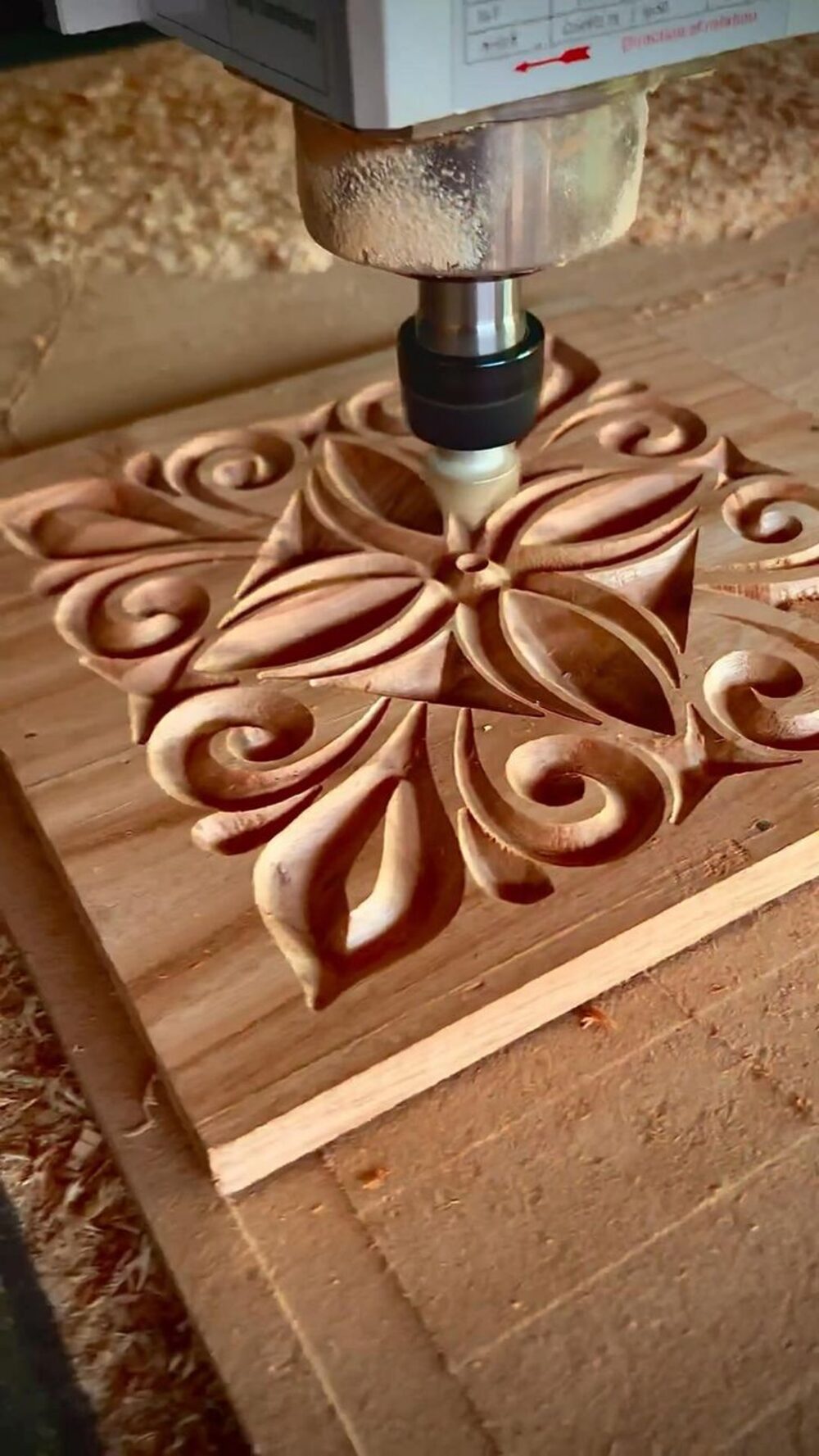CNC router mid-carve on a floral mandala panel at Khushi Crafts